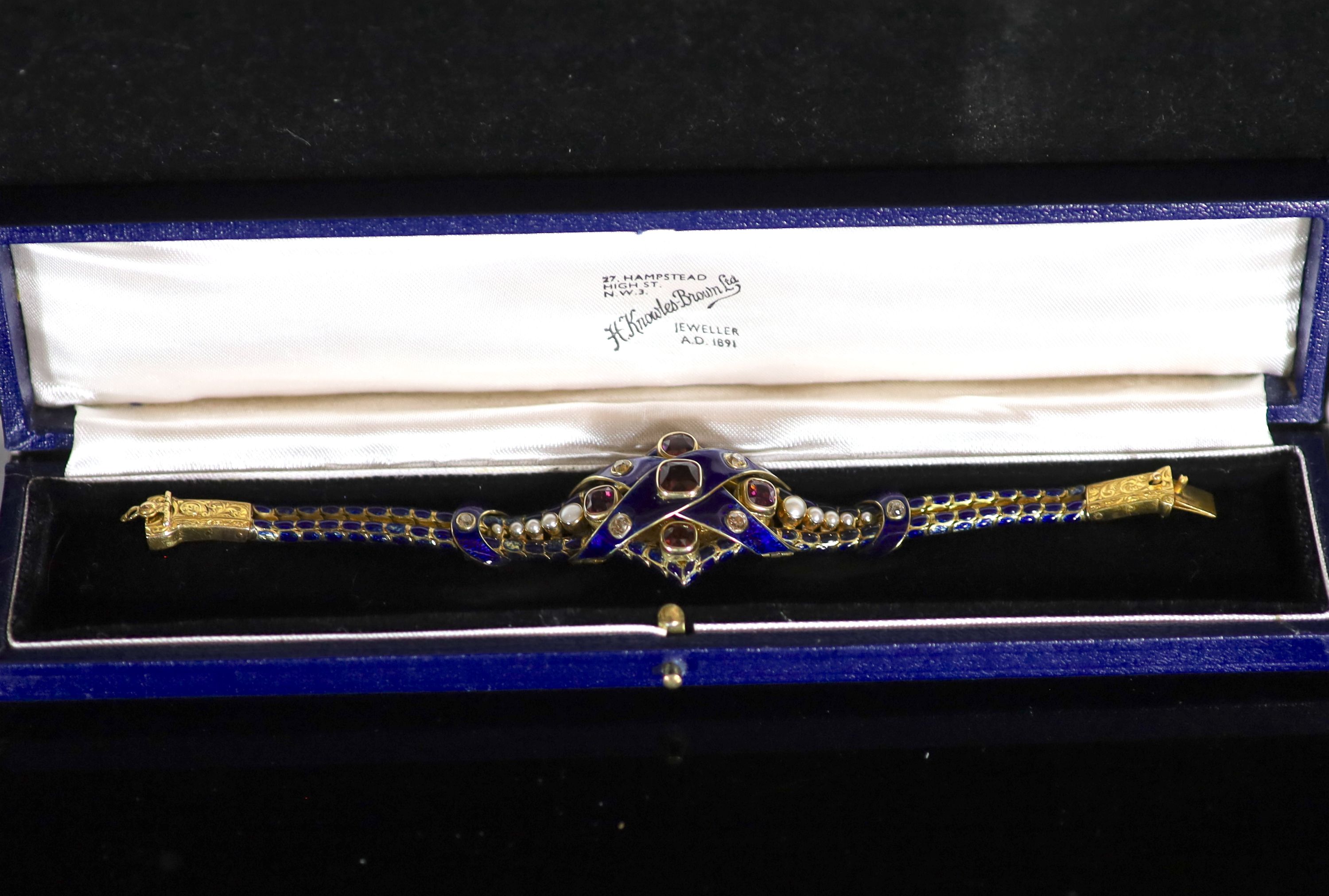 A good Victorian gold, blue enamel, old cut diamond, foil backed garnet and graduated split pearl set articulated memorial bracelet